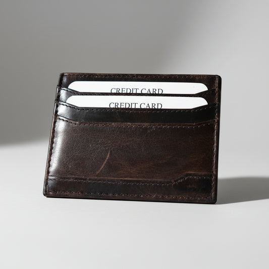 A brown leather card holder with a simple design,'.